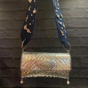 Silver Purse With Silver Details On Denim Belt.