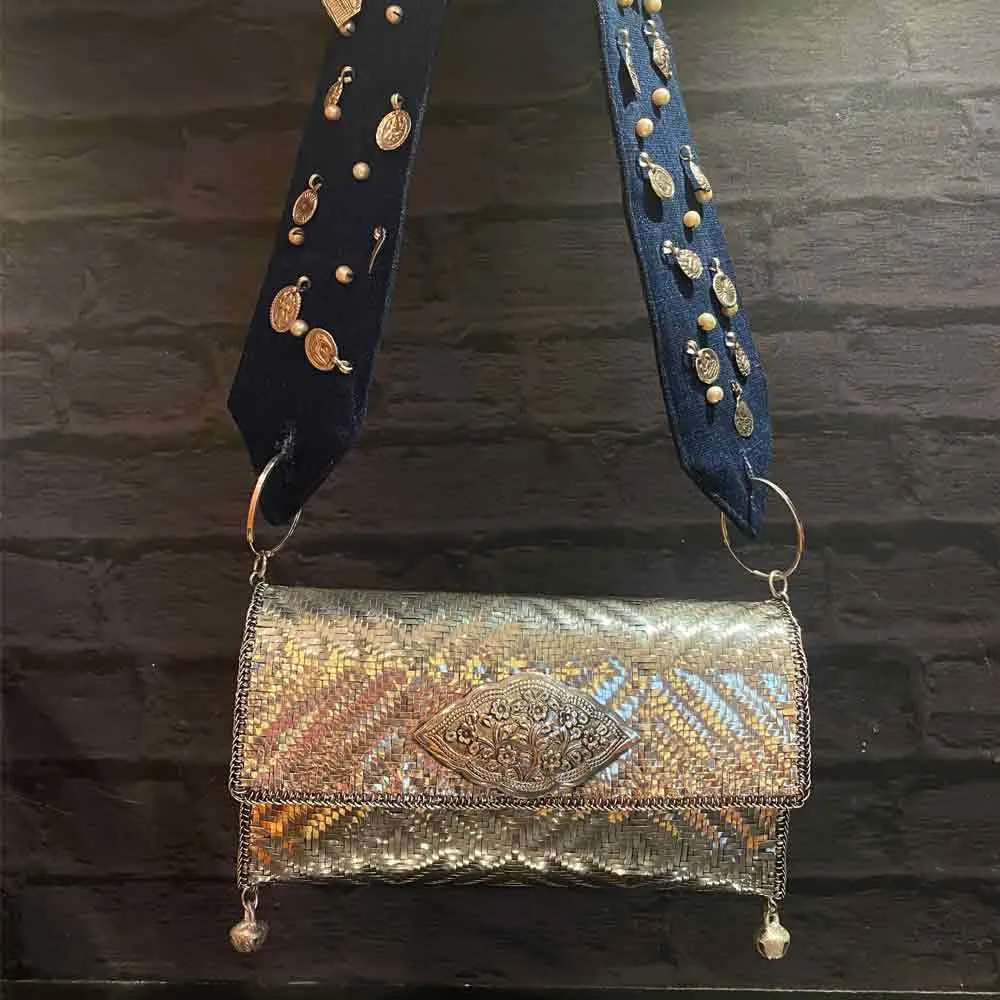 Silver Purse With Silver Details On Denim Belt.